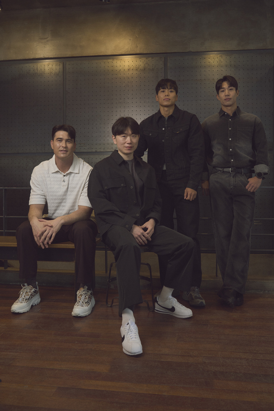 The top three contestants and showrunner Jang Ho-gi of season two of Netflix's "Physical: 100" pose during a press interview at a cafe in Jongno District, central Seoul, on Wednesday. From left: Andre Jin Coquillard, Jang, Amotti and Hong Beom-seok [NETFLIX]
