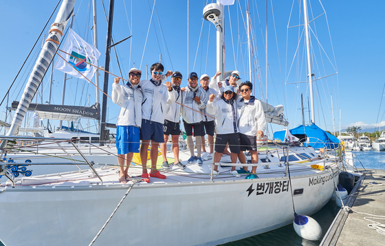 Clockwise from left, Choe Sang-back, Cho Byoung-chan, Kim Young-ho, Seo Kyoung-seok, Kwon Tae-woo, Timothee Franco, Kim Tae-ho and the yacht's skipper Song Ho-jun. Team Random () pose for a photograph after arriving at the Philippines’ Subic Bay on April 2. [BUNGAEJANGTER] 