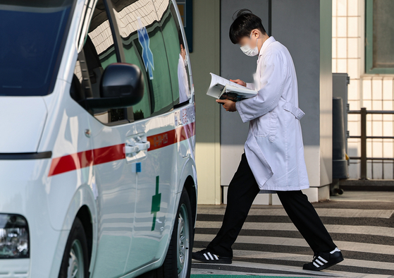 A medical professional walks in a compound of a general hospital in Seoul on Tuesday. [NEWS1]