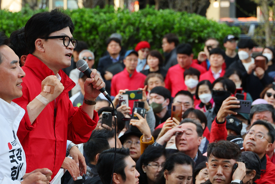 People Power Party (PPP) leader Han Dong-hoon, second from left, speaks during a campaign rally to support PPP candidates Park Min-sik and Kim Il-ho in Gangseo District, western Seoul, on Tuesday. [YONHAP]