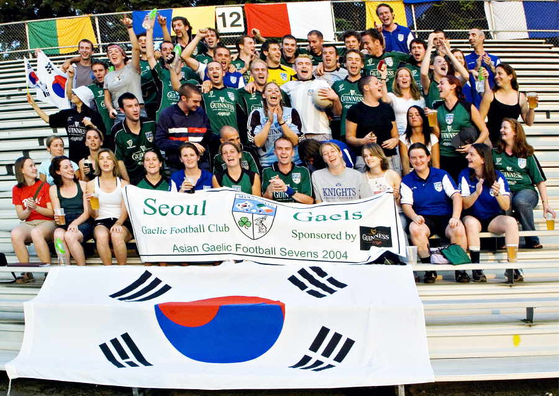 Early members of the Seoul Gaels pose with a flag. [TOM COYNER]