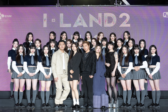 The 24 contestants on Mnet's upcoming girl group audition program "I-LAND2: N/a" pose for the camera alongside the producers of the program. From fourth from left are music producers 24 and VVN, main producer Taeyang and performance directors Monika and Leejung. [CJ ENM]