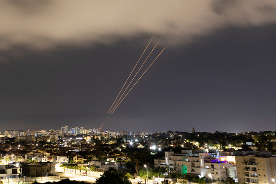 An anti-missile system operates after Iran launched drones and missiles toward Israel, as seen from Ashkelon, Israel on Sunday. [REUTERS/YONHAP]