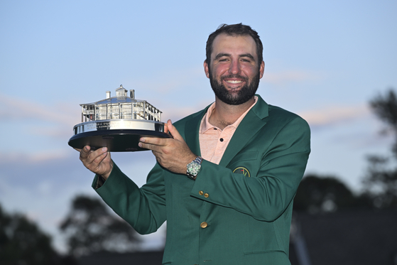 Scottie Scheffler poses with the winner's trophy as the 2024 Masters Champion after the final round of Masters Tournament at Augusta National Golf Club in Augusta, Georgia on Sunday. [GETTY IMAGES]