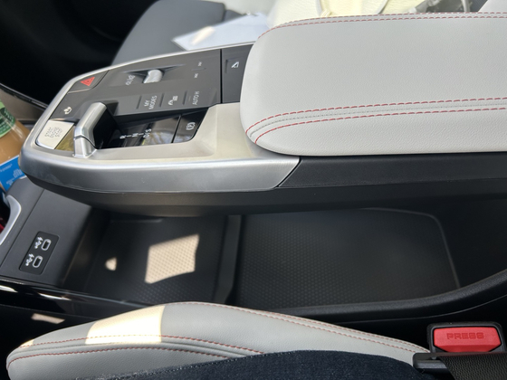 An open compartment is located under the center console armrest, providing a good space to put handbags and pouches. [SARAH CHEA]