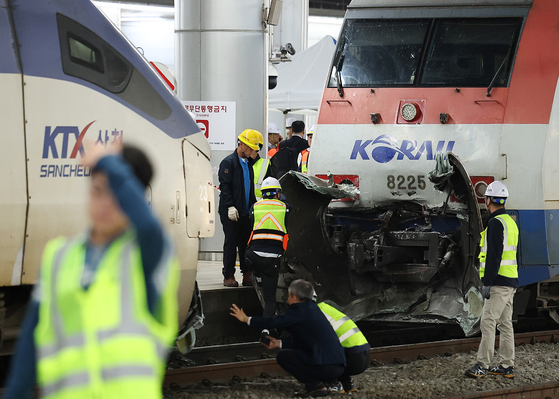 Officials clean up the train collision site, which occurred Thursday morning at Seoul Station in central Seoul. [YONHAP] 