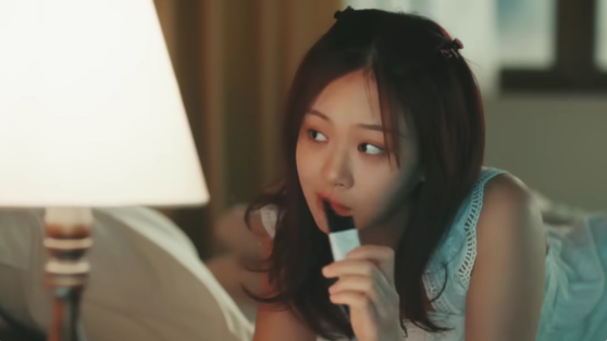 BIBI is eating bamyanggaeng, otherwise known as chestnut jelly stick, in the music video of her song "Bam Yang Gang" released in February. [SCREEN CAPTURE]