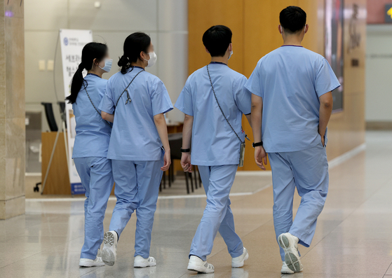 Medical personnel walk at a hospital in Seoul on Sunday morning.[NEWS1]