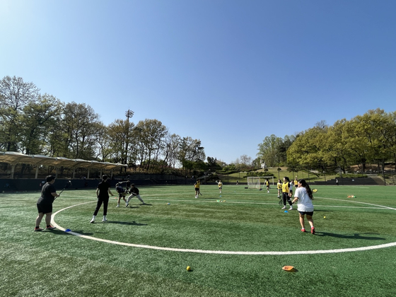 Mary, so far right that she can't possibly be contributing anything on the pitch, "participates" in a defensive drill at practice with the Seoul Jindos. [MARY YANG]