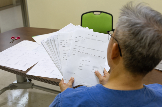 Medical staff at a university in Gyeonggi organizes the resignations of medical professors on Thursday, before submitting them. [NEWS1]