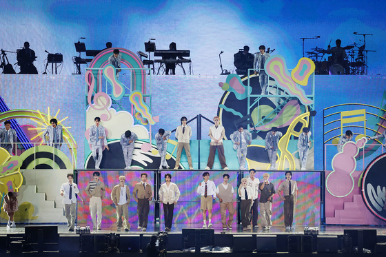 Seventeen performs at the boy band's ″'Follow Again' in Seoul' encore concert held Saturday at the Seoul World Cup Stadium in Mapo District, western Seoul. [PLEDIS ENTERTAINMENT]