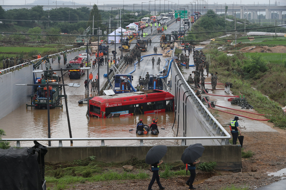 Fire authorities conduct a rescue operation after an underpass in Osong-eup, North Chungcheong, was hit by a flash flood on July 15, 2023. [NEWS1]