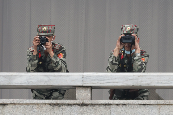 North Korean soldiers monitor the Joint Security Area on the inter-Korean border on April 16. [JOINT PRESS CORPS]