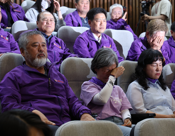 Relatives of victims who perished in the Itaewon crowd crush of Oct. 29, 2022, begin to cry in the National Assembly in Yeouido, western Seoul, after the legislature passed a bill mandating a new investigation into the disaster on Thursday afternoon. [NEWS1]