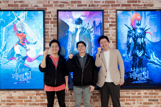 From left, Netmarble Neo's executive director Kim June-sung, producer Jin Seong-keon and Netmarble's business division director Moon Jun-ki pose to promote their role-playing game Solo Leveling: ARISE at Netmarble's headquarters in Guro District, western Seoul. [NETMARBLE][NETMARBLE]