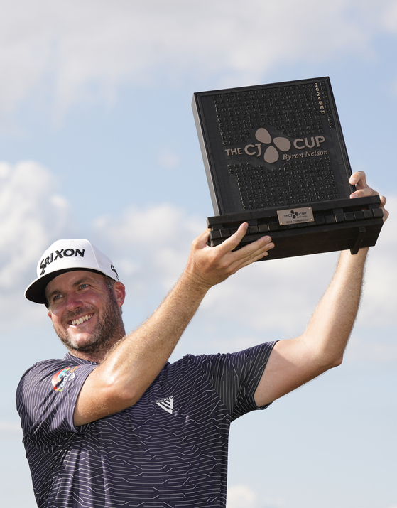 Taylor Pendrith of Canada poses with the CJ Cup trophy after putting in to win on the 18th green during the final round of The CJ Cup Byron Nelson at TPC Craig Ranch on Sunday in McKinney, Texas. [GETTY IMAGES]