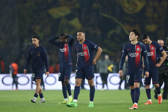 Paris Saint-Germain's Lee Kang-in, second from right, along with teammates Kylian Mbappe and Ousmane Dembele react as they walk off the pitch at the end of the UEFA Champions League semifinal second leg match against Borussia Dortmund at Parc des Princes in Paris on Tuesday. [AFP/YONHAP]