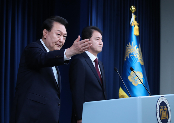 President Yoon Suk Yeol, left, gestures as he introduces former Vice Justice Kim Joo-hyun as his new senior secretary for civil affairs at the Yongsan presidential office in central Seoul on Tuesday. [JOINT PRESS CORPS]