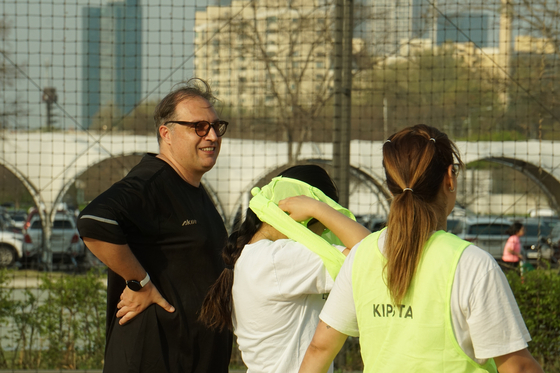 Matteo, left, gathers the players before explaining a drill. [SEOUL CALCIO FC]
