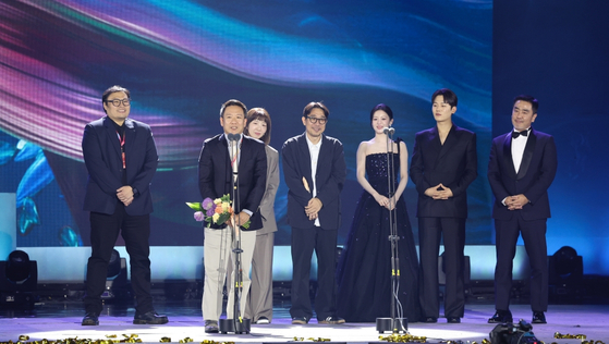 Cast and director of Disney+ original series ″Moving″ (2023) receive the Grand Prize at the television category of the 60th Baeksang Arts Awards on Tuesday evening in southern Seoul. [BAEKSANG ARTS AWARDS ORGANIZING COMMITTEE]
