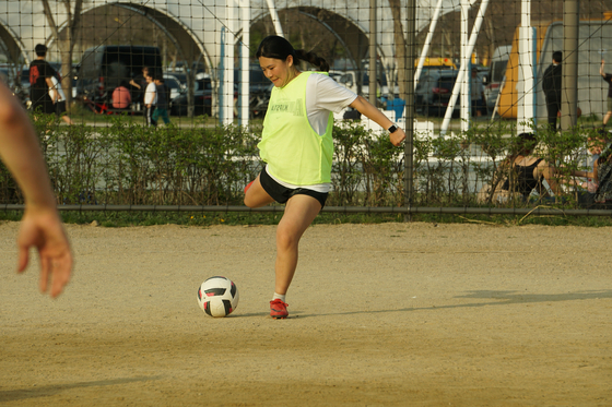 Mary attempts to embody the football greats, pointing her foot in the direction of the target and toward glory. [SEOUL CALCIO FC]