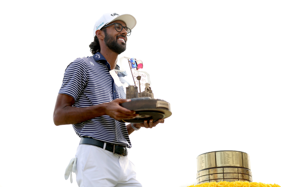 Akshay Bhatia of the United States poses with the trophy after winning the Valero Texas Open on the 18th hole of the first playoff during the final round of the Valero Texas Open at TPC San Antonio in San Antonio, Texas on April 7. [GETTY IMAGES]