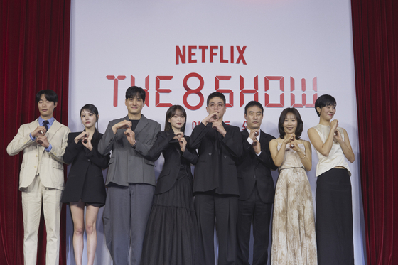 The cast of Netflix's ″The 8 Show″ pose for cameras during a press conference at the Ambassador Seoul-A Pullman Hotel in Jung District, central Seoul, on Friday. From left are actors Ryu Jun-yeol, Lee Yul-eum, Park Hae-joon, Chun Woo-hee, Park Jeong-min, Bae Seong-woo, Moon Jeong-hee and Lee Zoo-young. [NETFLIX]