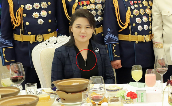 Ri Sol-ju, wife of North Korean leader Kim Jong-un, is a wearing an ICBM pendant necklace during a banquet last year in a screen capture from state media. [SCREEN CAPTURE]