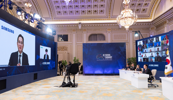 Samsung Electronics Executive Chairman Lee Jae-yong, left on the screen, shares his vision for safe and inclusive AI at the AI Seoul Summit held on Tuesday evening. [PRESIDENTIAL OFFICE]