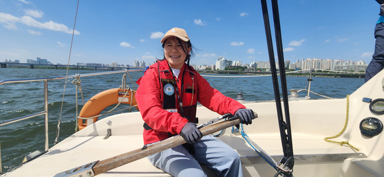 Mary is definitely, totally, absolutely not nervous at all as she skippers for the very first time. Names have been blurred. [SAILING PARADISE]