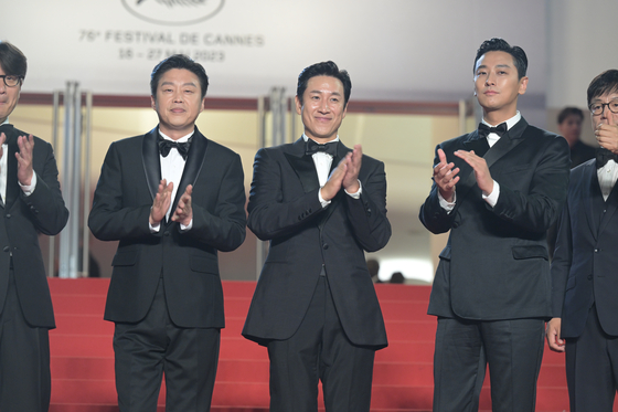 Actor Lee Sun-kyun, center, walks on the 76th Cannes Film Festival's red carpet on May 23, 2023 for his film ″Project Silence″, which was invited to the festival's Midnight Screening section. [CJ ENM] 