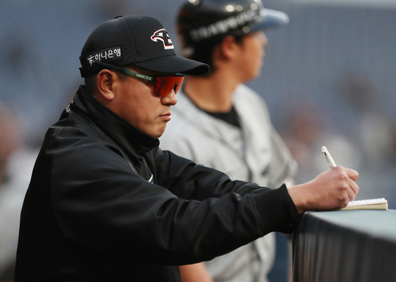 Hanwha Eagles manager Choi Won-ho scribbles in his notebook during a game against the NC Dinos at Changwon NC Park in Changwon, South Gyeongsang on April 17. [NEWS1] 