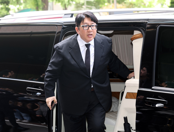 HYBE Chairman Bang Si-hyuk enters Lotte Hotel Seoul on Tuesday for a tea meeting with UAE President Mohamed bin Zayed Al Nahyan. [YONHAP]