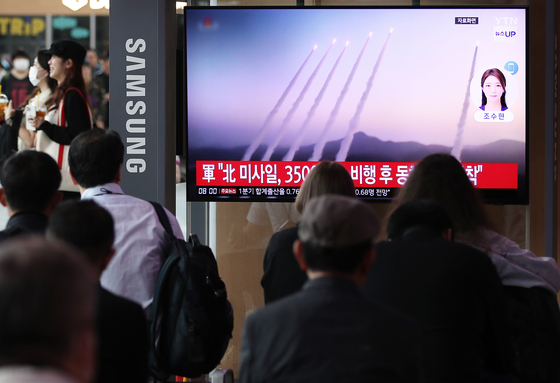 Citizens watch a news report on North Korea firing around 10 short-range ballistic missiles into the East Sea at Seoul Station in central Seoul on Thursday morning. [NEWS1]