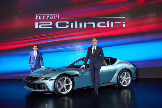 Emanuele Carando, global product marketing director at Ferrari, and Kim Kwang-cheol, CEO of FMK, the local distributor of Ferrari, pose with the 12Cilindri at an Asia Premiere event in Incheon on Thursday. [FERRARI]