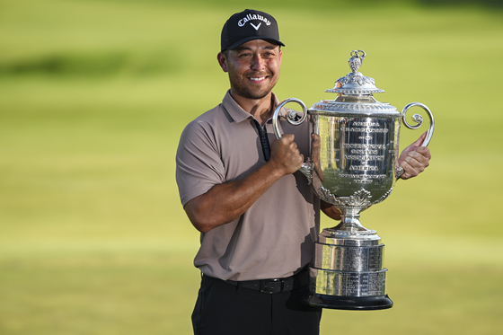 Xander Schauffele smiles with the Wanamaker Trophy after his one stroke victory in the final round of the 106th PGA Championship at Valhalla Golf Club in Louisville, Kentucky on May 19. [GETTY IMAGES] 