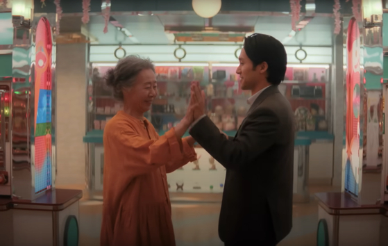 Youn Yuh-jung, left, dancing with Jin Ha, right, on the release date announcement YouTube video announcing the second season of ″Pachinko." [APPLE TV+]