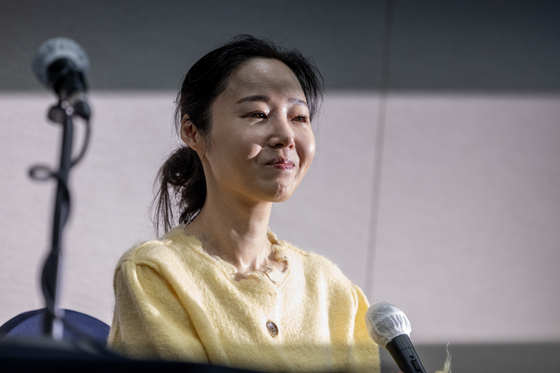 CEO of ADOR, agency to girl group NewJeans, Min Hee-jin smiles during a press conference held Friday in central Seoul. [JOINT PRESS CORPS]
