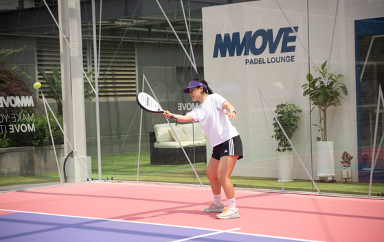 Mary practices her forehand moments after picking up a padel paddle for the very first time. [MMOVE]