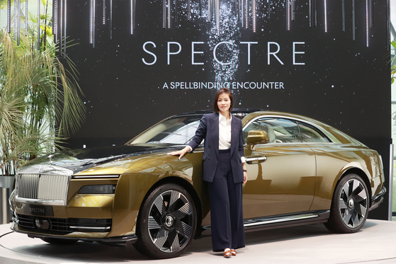 Irene Nikkein, director for the Asia-Pacific region at Rolls-Royce Motor Cars, poses for a photo beside the all-electric Spectre coupe in Gangnam District, southern Seoul, in June. [YONHAP] 