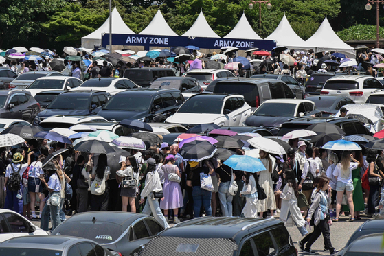 Fans of boy band BTS attend the 2024 Festa event in southern Seoul on June 13, a day after member Jin was discharged from his military service. [AFP/YONHAP]