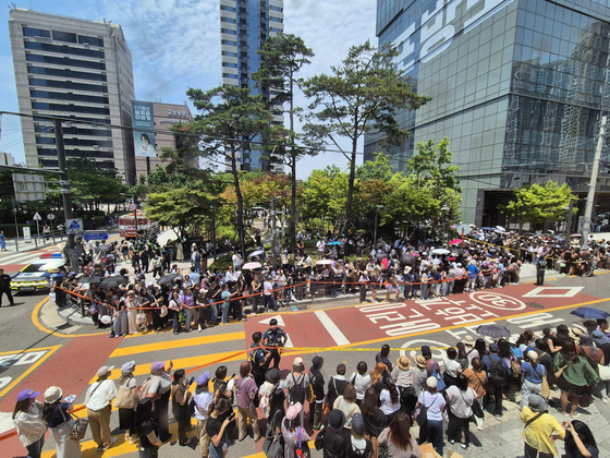 Fans stand outside HYBE headquarters in Yongsan, central Seoul, on June 12 to welcome BTS member Jin on the day he finished his military duty. [HYBE]