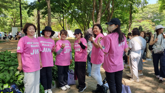 A group of Japanese BTS fans wear matching T-shirts designed by one of the group's members on June 13 while they stand in line to enter the 2024 Festa event at the Seoul Sports Complex in southern Seoul. [YOON SO-YEON]