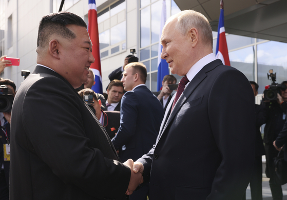 North Korean leader Kim Jong-un, left, and Russian President Vladimir Putin shake hands during their meeting at the Vostochny Cosmodrome, a spaceport in the far eastern Amur region in Russia, on Sept. 13, 2023, their first reunion in over four years. [AP/YONHAP]