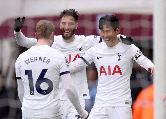 Tottenham Hotspur's Timo Werner, left, celebrates with Rodrigo Bentancur, center, and Son Heung-min on March 10.  [REUTERS/YONHAP]
