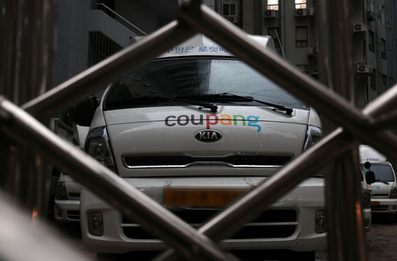 A Coupang delivery truck is parked in Seoul in February. The New York-listed e-commerce giant, recently fined 140 billion won for allegedly manipulating its search results, is reportedly under investigation by Korea's Fair Trade Commission for using dark patterns to raise the prices of, and keep users subscribed to, its paid membership service. [YONHAP]