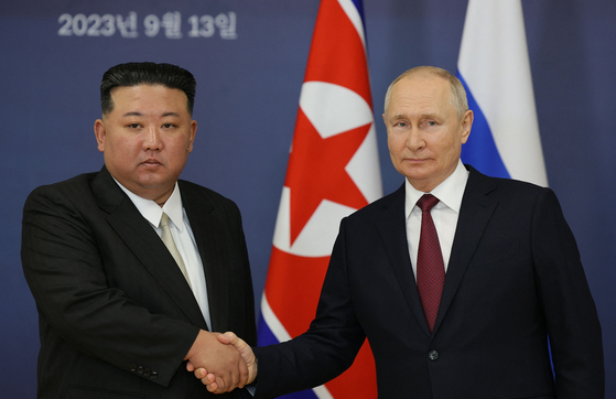 Russian President Vladimir Putin and North Korean leader Kim Jong-un shake hands during their meeting at the Vostochny Cosmodrome on Sept. 13, 2023. [AFP/YONHAP]