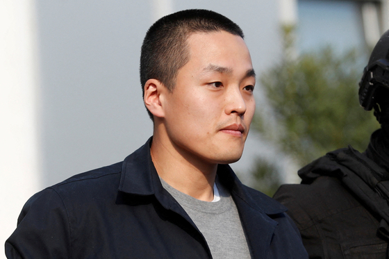 Terraform Labs co-founder Do Kwon is escorted by police officers in Podgorica, Montenegro, on March 23. [REUTERS/YONHAP]