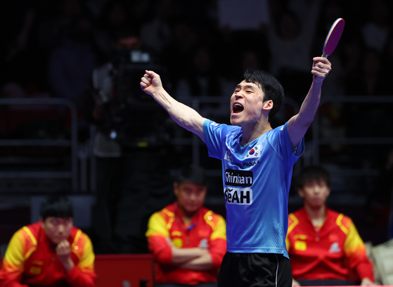 Korea's Jang Woo-jin celebrates after a 2024 World Team Table Tennis Championships men's team match against China's Wang Chuqin at BEXCO Convention Centre in Busan on Feb. 24. [YONHAP] 