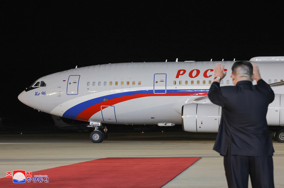 North Korean leader Kim Jong-un waves goodbye as Russian President Vladimir Putin’s presidential jet heads to Vietnam after a departure ceremony at Sunan airport outside Pyongyang on Wednesday, in a photo released by the North’s state-run Korean Central News Agency Thursday. [YONHAP]